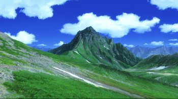 Movie still from “Wolf Children” (2012), directed by Mamoru Hosoda – A green mountain with a blue cloudy sky above it; Extreme Wide shot, High angle