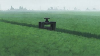 Movie still from “Wolf Children” (2012), directed by Mamoru Hosoda – An image of an object in the middle of a green field; Extreme Wide shot, High angle