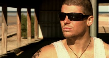 Movie still from “Wolf Creek” (2005), directed by Greg McLean – A person wearing sunglasses; Close Up shot, Low angle