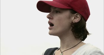 Movie still from “Wolf Creek” (2005), directed by Greg McLean – A woman wearing a red hat and a white shirt; Close Up shot, Low angle