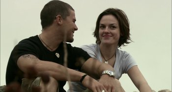 Movie still from “Wolf Creek” (2005), directed by Greg McLean – A man and a woman sitting next to each other; Close Up shot, Low angle