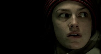 Movie still from “Wolf Creek” (2005), directed by Greg McLean – A woman with a red hat is looking at the camera; Extreme Close Up shot, Low angle