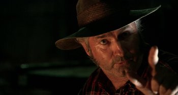 Movie still from “Wolf Creek” (2005), directed by Greg McLean – A person wearing a hat; Close Up shot, Low angle