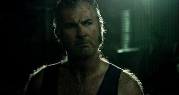 Movie still from “Wolf Creek” (2005), directed by Greg McLean – A person wearing a tank top; Close Up shot, Over the shoulder angle