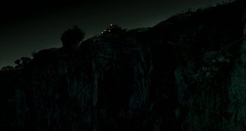 Movie still from “Wolf Creek” (2005), directed by Greg McLean – A car is parked on the side of a hill at night; Extreme Wide shot, Low angle