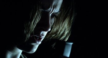 Movie still from “Wolf Creek” (2005), directed by Greg McLean – A person with long hair; Close Up shot, Low angle