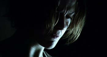 Movie still from “Wolf Creek” (2005), directed by Greg McLean – A person's face in the dark; Close Up shot, Low angle