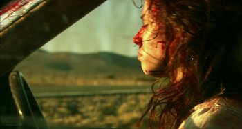 Movie still from “Wolf Creek” (2005), directed by Greg McLean – A woman with blood all over her face looking out a window; Close Up shot, Low angle