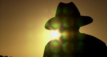 Movie still from “Wolf Creek” (2005), directed by Greg McLean – A person wearing a hat and a sun flare; Extreme Close Up shot, Low angle