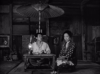 A man and a woman sitting in front of a table