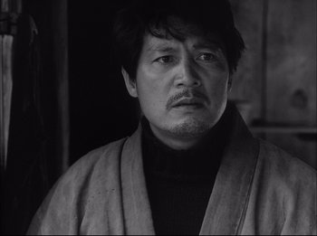 Black and white photograph of a man wearing a robe