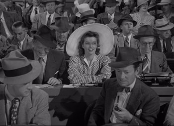 Movie still from “Woman of the Year” (1942), directed by George Stevens – An old photo of a crowd of people in suits and hats; Medium shot, High angle