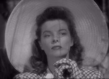 Movie still from “Woman of the Year” (1942), directed by George Stevens – A black - and - white photo of a woman in a hat; Close Up shot, High angle