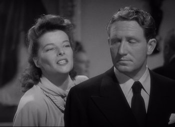 Movie still from “Woman of the Year” (1942), directed by George Stevens – A man and a woman standing next to each other; Close Up shot, Low angle