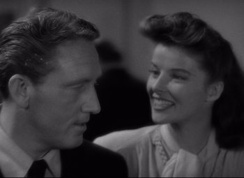 Movie still from “Woman of the Year” (1942), directed by George Stevens – A man and a woman are smiling at each other; Close Up shot, Over the shoulder angle