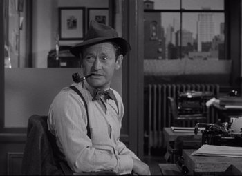 Movie still from “Woman of the Year” (1942), directed by George Stevens – An old man sitting in a chair in front of a window; Medium shot, High angle