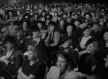 Movie still from “Woman of the Year” (1942), directed by George Stevens – A group of people sitting in a room; Medium shot, High angle