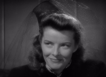 Movie still from “Woman of the Year” (1942), directed by George Stevens – An old photo of a woman with a veil over her head; Close Up shot, Over the shoulder angle