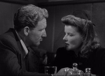 Movie still from “Woman of the Year” (1942), directed by George Stevens – An older man and a young woman sitting at a dinner table; Close Up shot, Low angle