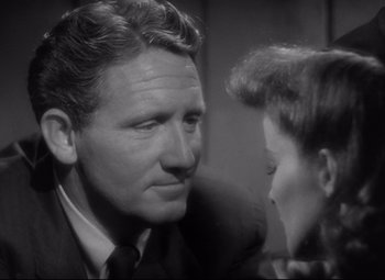 Movie still from “Woman of the Year” (1942), directed by George Stevens – An old photo of a man and a young woman looking at each other; Close Up shot, Over the shoulder angle