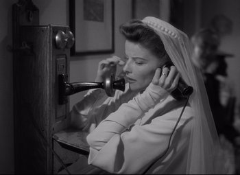 Movie still from “Woman of the Year” (1942), directed by George Stevens – An old photo of a woman talking on a phone; Medium shot, Low angle