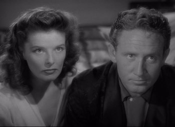 Movie still from “Woman of the Year” (1942), directed by George Stevens – A man and a woman standing next to each other; Close Up shot, High angle