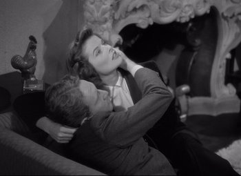 Movie still from “Woman of the Year” (1942), directed by George Stevens – A man and a woman sitting on top of each other; Medium shot, High angle