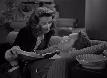Movie still from “Woman of the Year” (1942), directed by George Stevens – A man and a woman laying on a couch; Medium shot, High angle