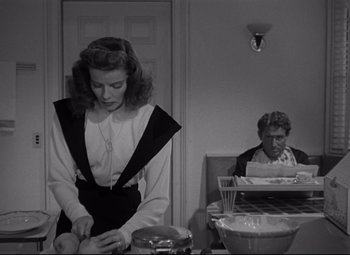 Movie still from “Woman of the Year” (1942), directed by George Stevens – A woman standing in front of a man in a room; Medium shot, Over the shoulder angle