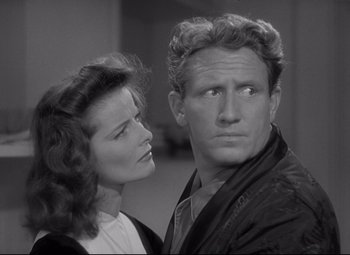 Movie still from “Woman of the Year” (1942), directed by George Stevens – A man and a woman standing next to each other in a room; Close Up shot, Over the shoulder angle