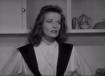Movie still from “Woman of the Year” (1942), directed by George Stevens – A black and white photo of a woman in a kitchen; Close Up shot, Low angle