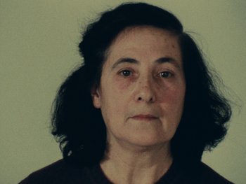Movie still from “Women Reply” (1975), directed by Agnès Varda – An older woman is looking directly at the camera; Close Up shot, Low angle