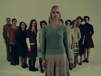 Movie still from “Women Reply” (1975), directed by Agnès Varda – A group of women standing next to each other in a line; Wide shot, Low angle