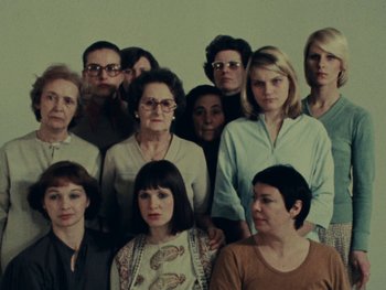 Movie still from “Women Reply” (1975), directed by Agnès Varda – A group of people posing for a picture; Medium shot, High angle