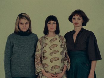 Movie still from “Women Reply” (1975), directed by Agnès Varda – A group of three women standing next to each other; Medium shot, High angle
