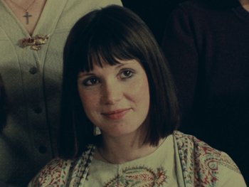 Movie still from “Women Reply” (1975), directed by Agnès Varda – A person wearing a dress; Close Up shot, High angle