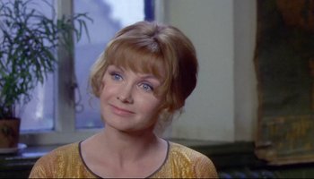 Movie still from “Women in Love” (1969), directed by Ken Russell – A person wearing a yellow shirt; Close Up shot, Over the shoulder angle