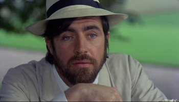 Movie still from “Women in Love” (1969), directed by Ken Russell – A man with a beard wearing a hat and a jacket; Close Up shot, Low angle