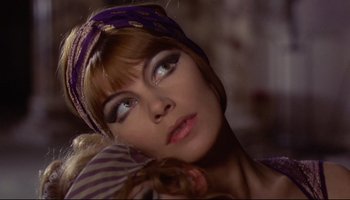 Movie still from “Women in Love” (1969), directed by Ken Russell – A person wearing a head scarf; Close Up shot, Low angle