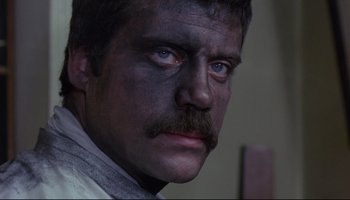 Movie still from “Women in Love” (1969), directed by Ken Russell – A person with a beard and mustache; Close Up shot, High angle