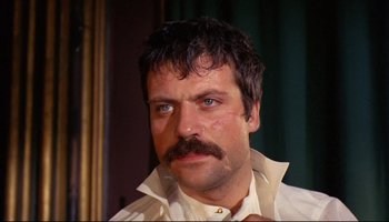 Movie still from “Women in Love” (1969), directed by Ken Russell – A person wearing a shirt and a tie; Close Up shot, Low angle