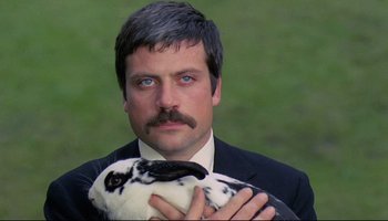 Movie still from “Women in Love” (1969), directed by Ken Russell – A man holding a stuffed animal in front of him; Close Up shot, Low angle