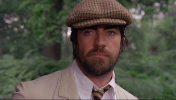 Movie still from “Women in Love” (1969), directed by Ken Russell – A man wearing a hat and a tie; Close Up shot, Low angle