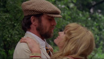Movie still from “Women in Love” (1969), directed by Ken Russell – A man and a woman are kissing each other; Close Up shot, Low angle
