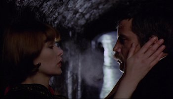 Movie still from “Women in Love” (1969), directed by Ken Russell – A man and a woman are looking at one another; Close Up shot, Low angle