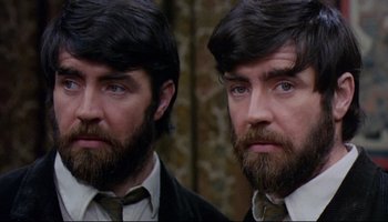 Movie still from “Women in Love” (1969), directed by Ken Russell – A man with long hair and a beard is looking into the mirror; Close Up shot, Over the shoulder angle