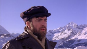 Movie still from “Women in Love” (1969), directed by Ken Russell – A man with a long beard wearing a hat; Close Up shot, Low angle