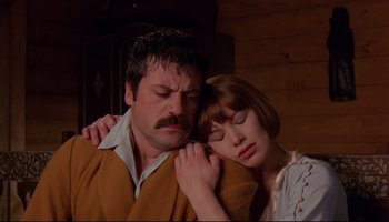 Movie still from “Women in Love” (1969), directed by Ken Russell – A man and a woman hugging each other in front of a wooden wall; Close Up shot, Low angle