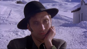 Movie still from “Women in Love” (1969), directed by Ken Russell – A man wearing a hat and a tie; Close Up shot, Low angle