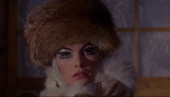 Movie still from “Women in Love” (1969), directed by Ken Russell – A person wearing a fur hat; Close Up shot, Low angle